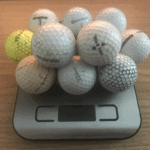 12 golf balls on a weight scale